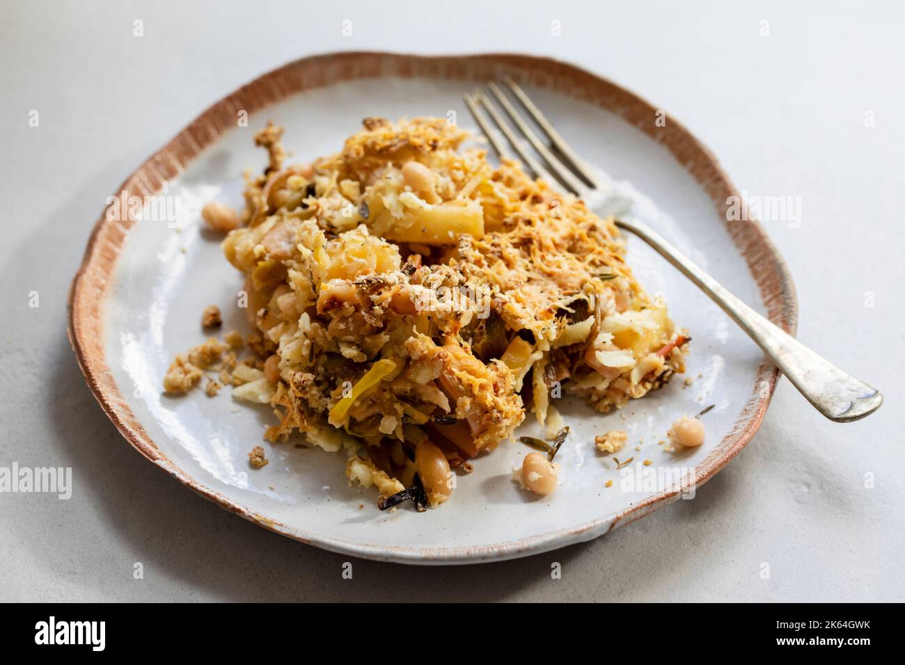 Vegan dish of parsnip, leek and bean crumble with crispy topping Stock Photo