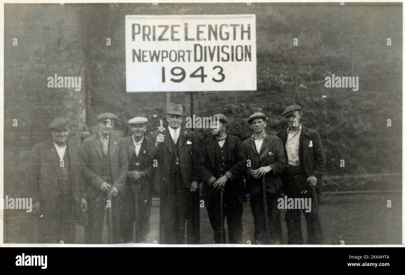 Lengthmen - Prize Length, Newport Division, 1943 - Newport, South Wales. The term Lengthsman was coined in the 18th century in a concept rooted in the Tudor Era as far back as War of the Roses and enclosure. Originally, it referred to someone who kept/maintained a 'length' of road neat, tidy and passable in the Middle Ages, with particular emphasis on boundary marking. Lengthsmen were used on canals and railways from the beginnings of both. On land, lengthsmen might be responsible for a few miles between adjacent villages and especially on commonage. Stock Photo