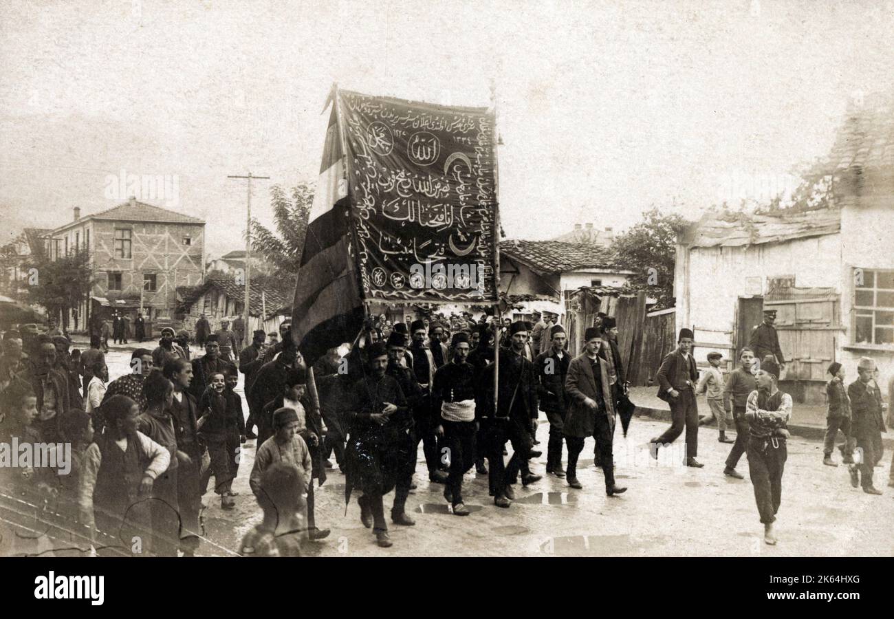 Patriotic Turkish marchers at the start of Italo-Turkish War - carrying a banner adorned with two Koranic quotes, that make clear that it is God who grants victory. The Italo-Turkish or Turco-Italian War was fought between the Kingdom of Italy and the Ottoman Empire from 29 September 1911, to 18 October 1912. As a result of this conflict, Italy captured the Ottoman Tripolitania Vilayet, of which the main sub-provinces were Fezzan, Cyrenaica, and Tripoli itself. Stock Photo