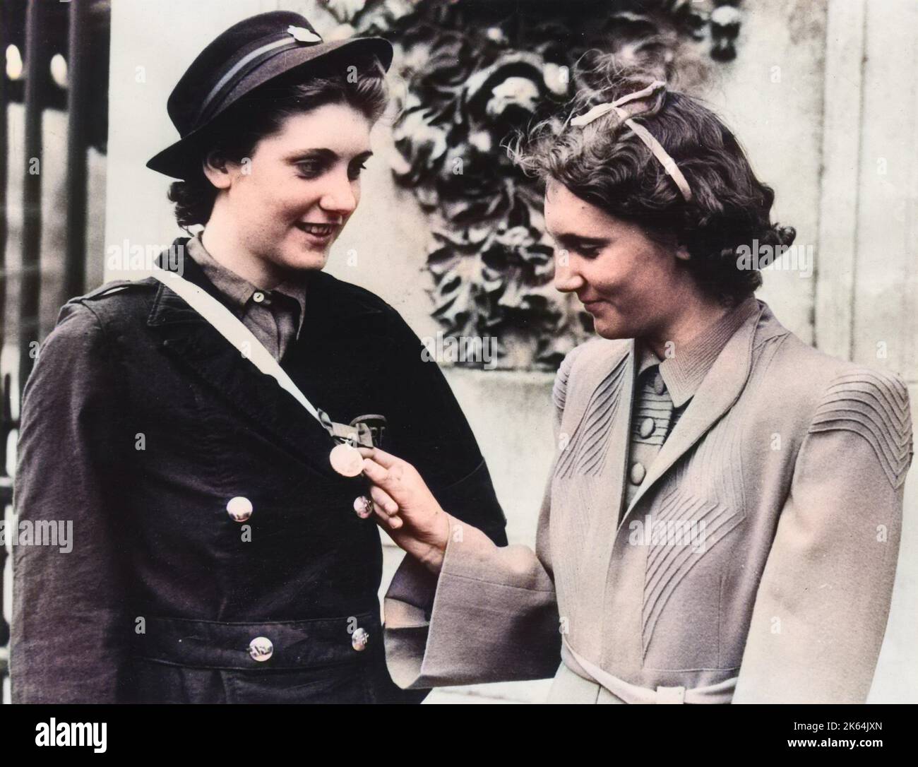 Betty Quinn - Coventry ARP Worker, has her George Medal admired by her sister, Joyce. Betty was the youngest recipient of the GM when they were presented for the first time at a recent Buckingham Palace investiture. Betty was recognised for her courageous work in rescuing people from shelters during her ARP duties. Stock Photo