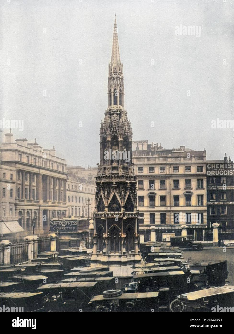 The Victorian replica of the Eleanor Cross at London Charing Cross station, surrounded by taxi cars. Stock Photo
