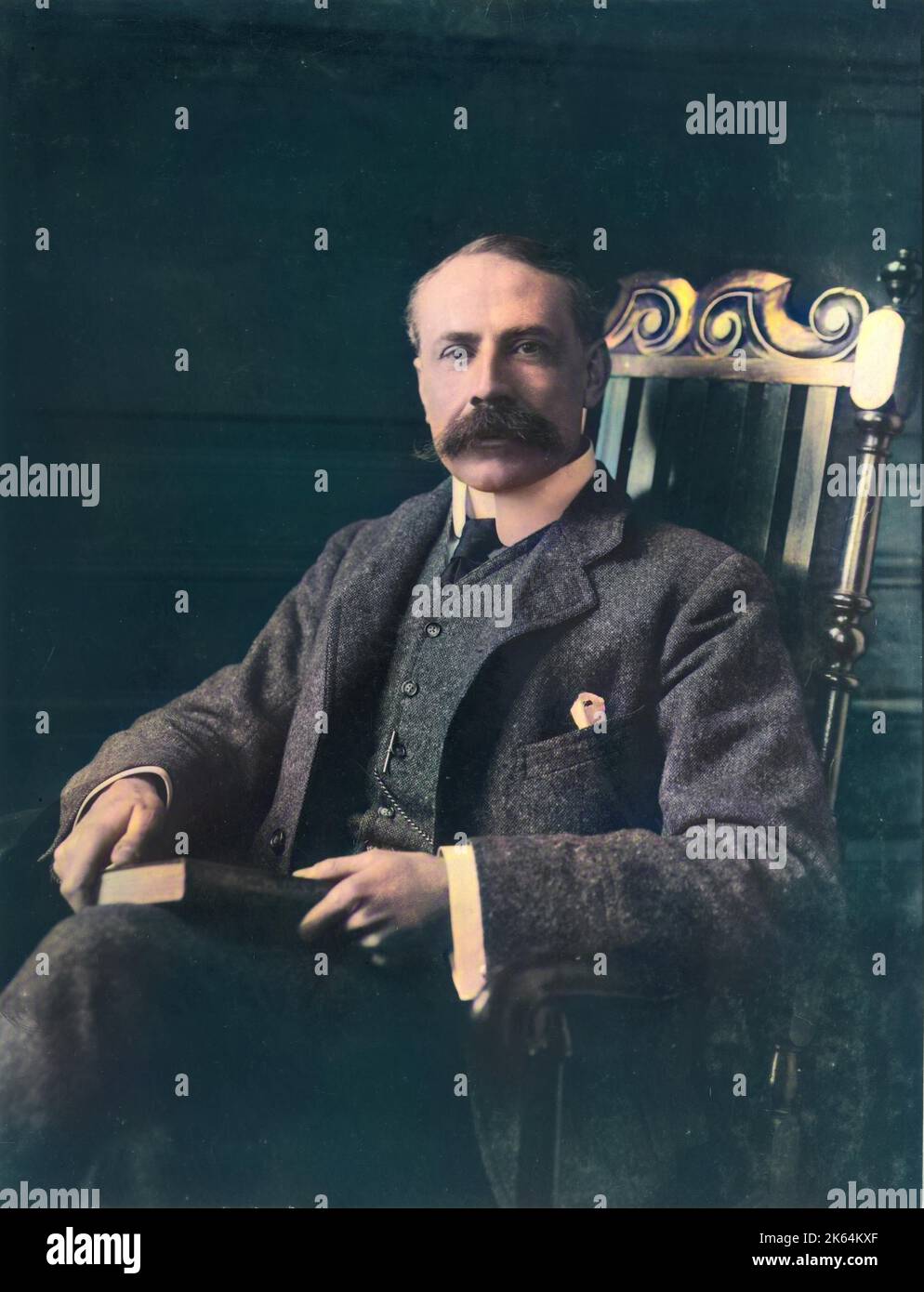 Sir Edward William Elgar, 1st Baronet, OM, GCVO (1857-1934), English composer.  He composed oratorios, chamber music, symphonies, instrumental concertos, and songs, and was appointed Master of the King's Musick in 1924.  He is best known for the Enigma Variations and the Pomp and Circumstance Marches.  Seen here sitting in a chair with a book on his knee. Stock Photo
