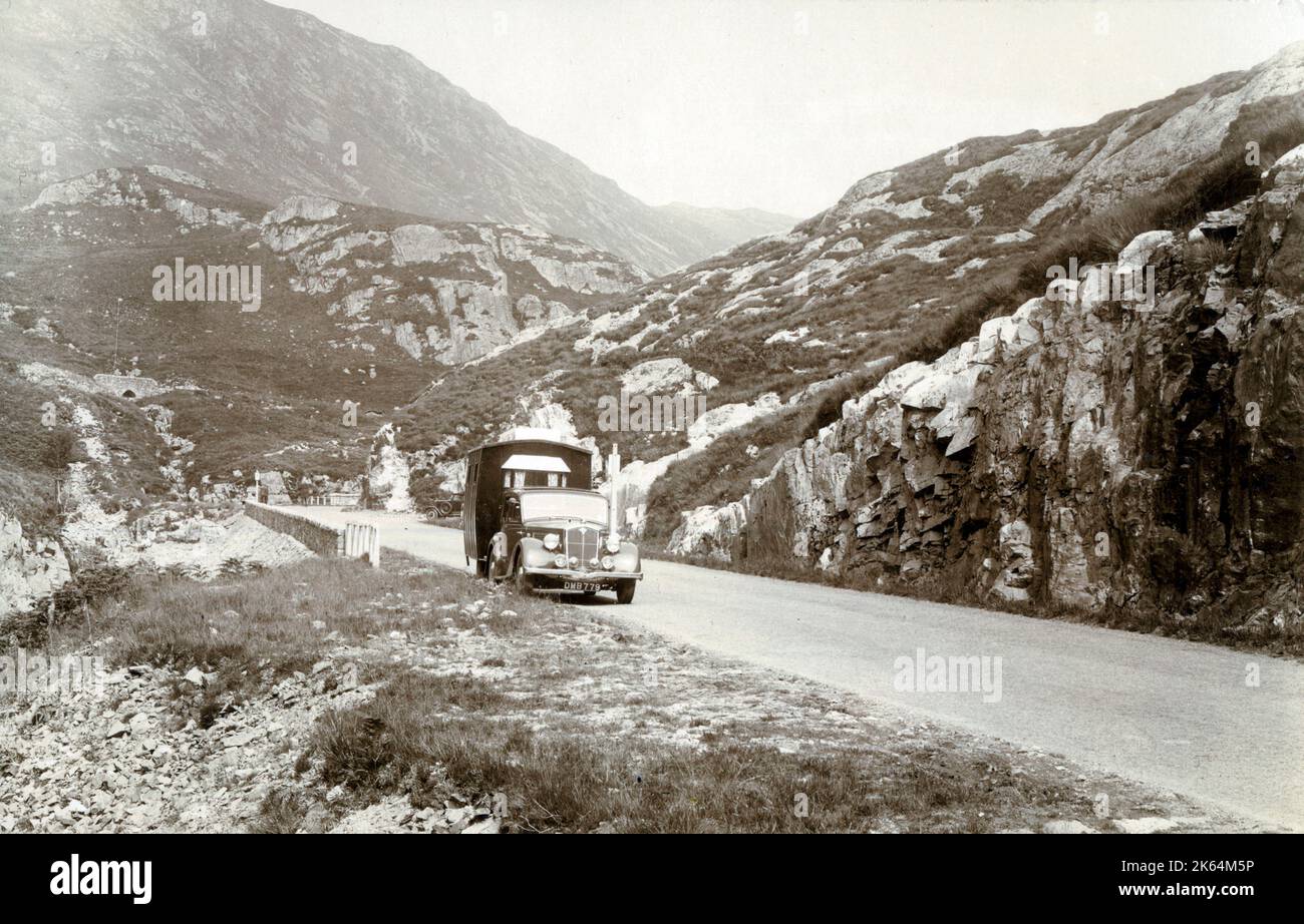 An Early Caravan trundling through the Pass of Glencoe, Scotland Stock Photo