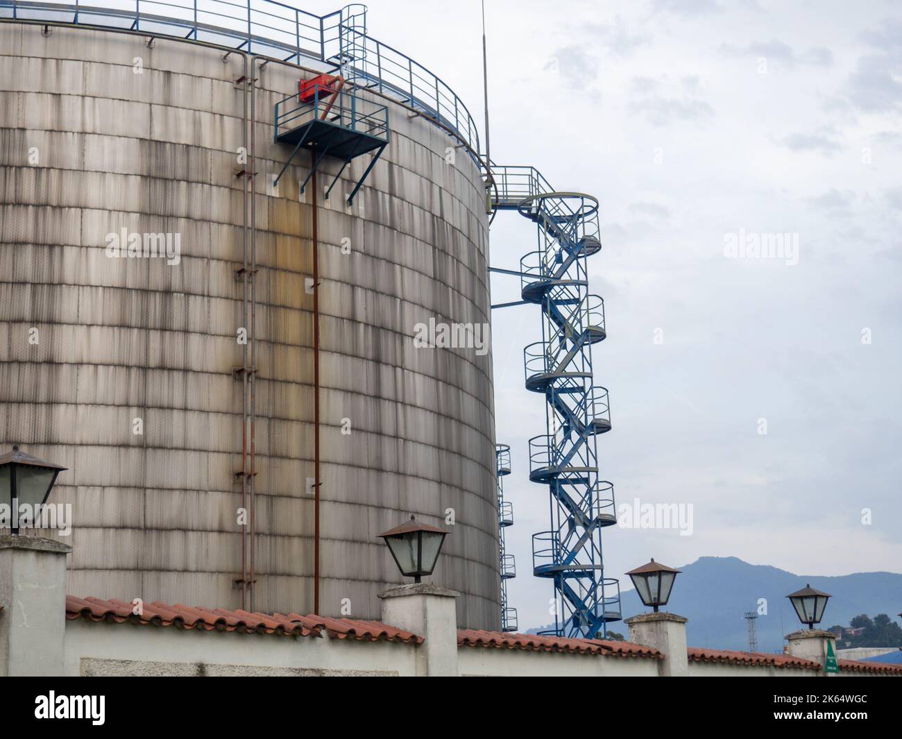 Large fuel tanks. Tanks and ladders of the tank farm. The gloomy
