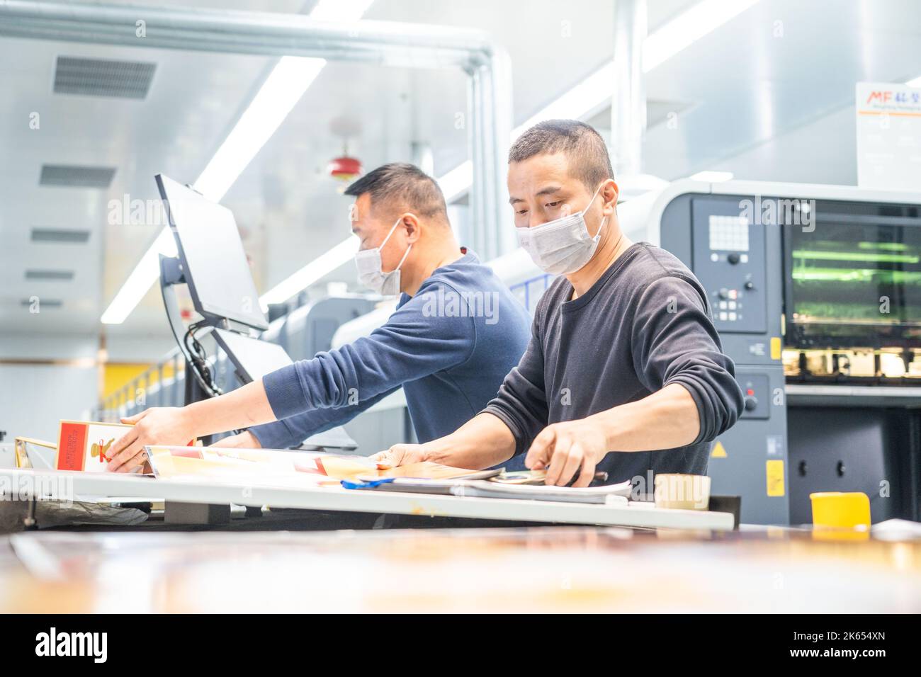 BIJIE, CHINA - OCTOBER 11, 2022 - Workers work on a production line of an enterprise in the high-tech Industry Development zone in Bijie, Guizhou prov Stock Photo