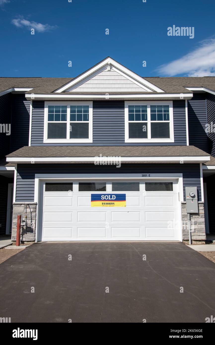 Blaine, Minnesota. Newly built townhome with for sale sign on garage