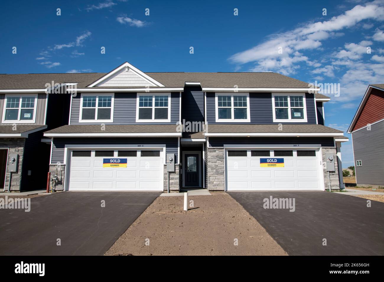 Blaine, Minnesota. A pair of brand new townhomes with for sale signs on