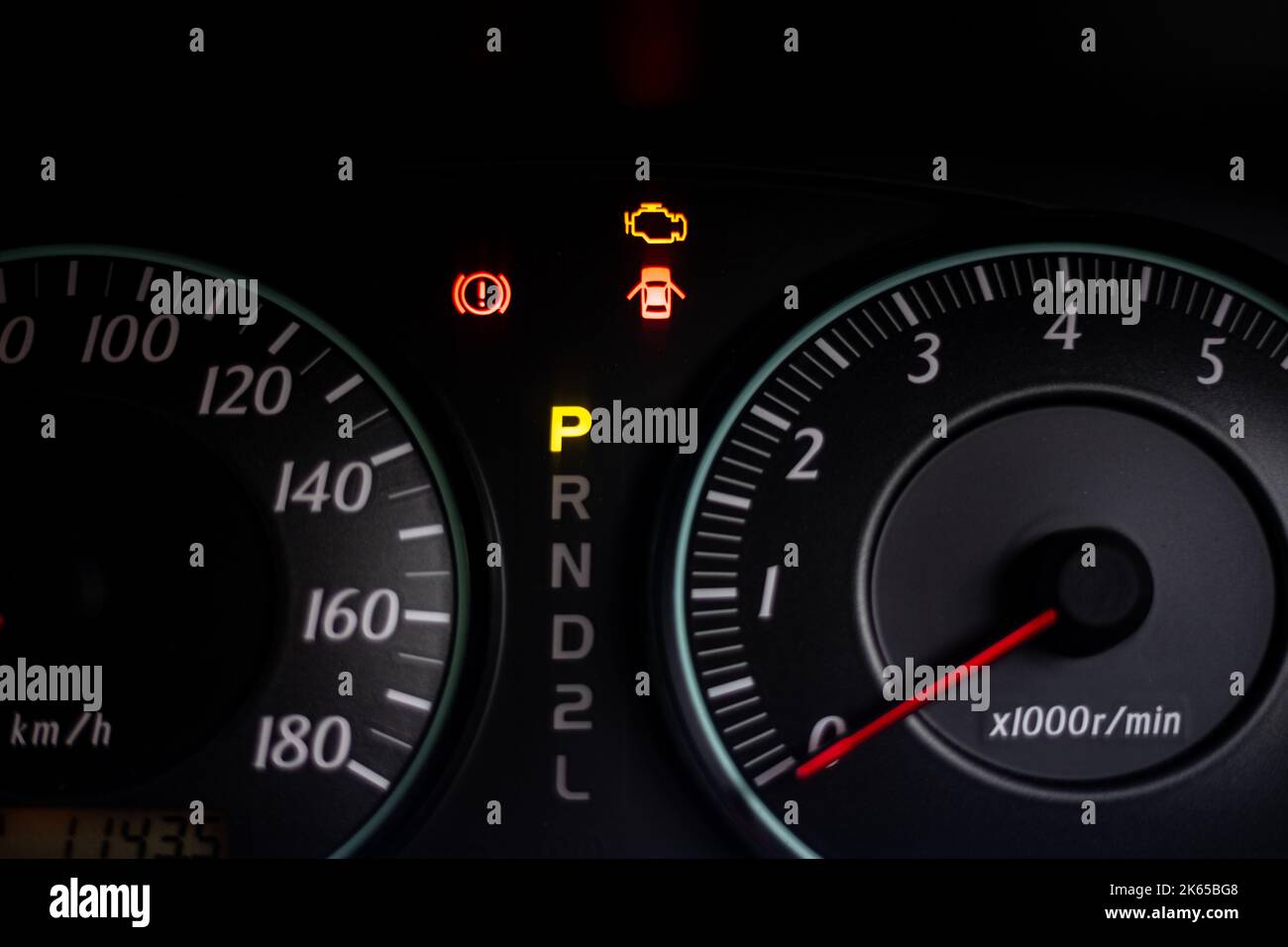The warning lights of car engine check, door opened, parked and hand break in the speedometer of a vehicle Stock Photo