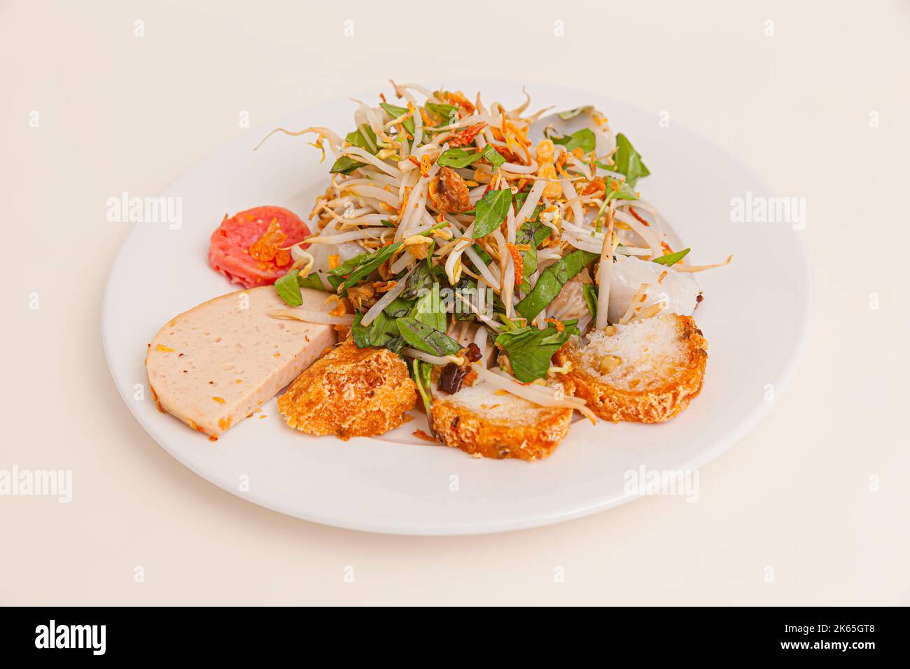 Banh Cuon, vietnamese steamed rice rolls with minced meat inside, Vietnamese food isolated on white background, close-up Stock Photo
