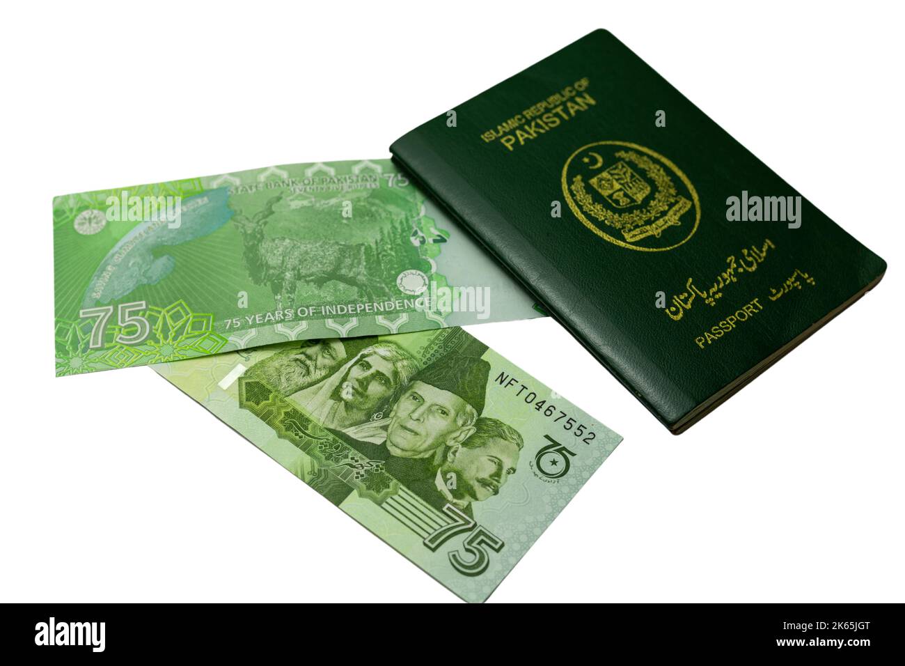 Pakistan commemorative new 75 rupees banknotes with a Pakistani green passport on a white isolated background Stock Photo