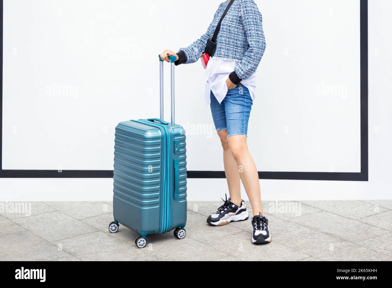 Female traveler walking with blue suitcase on white background Stock ...