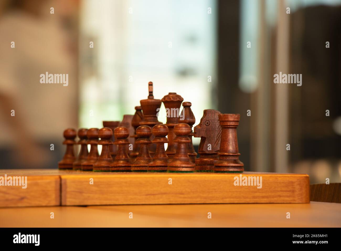 brown chess board with figures on a wooden table in a cafe, playing chess  Stock Photo - Alamy