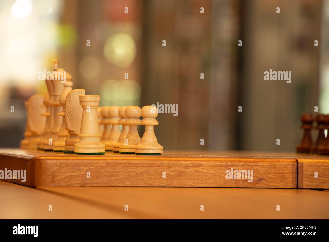 brown chess board with figures on a wooden table in a cafe, playing chess  Stock Photo - Alamy