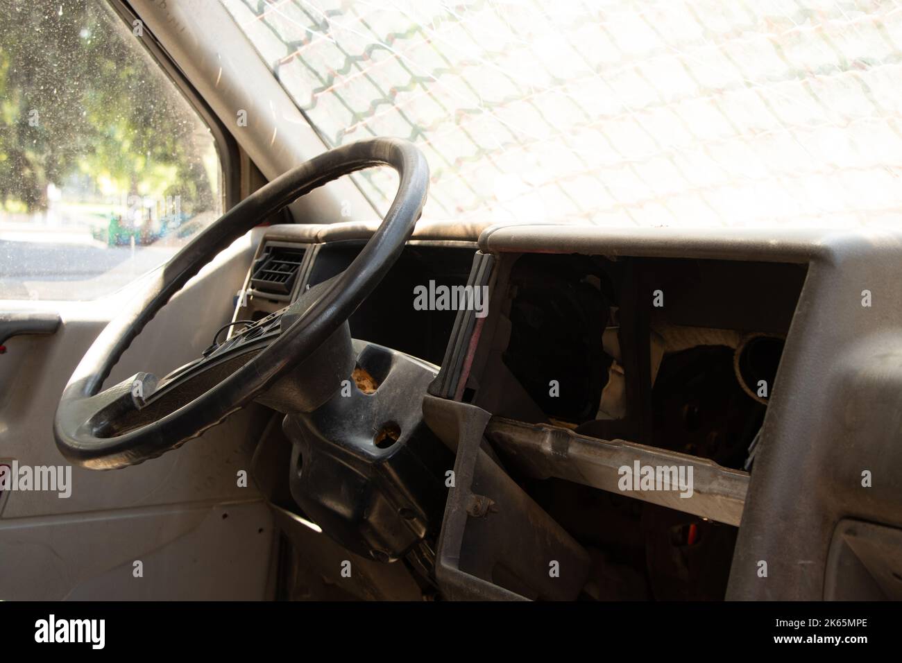old broken military vehicle with bars on the front window, the car after the passage of hostilities, auto Stock Photo