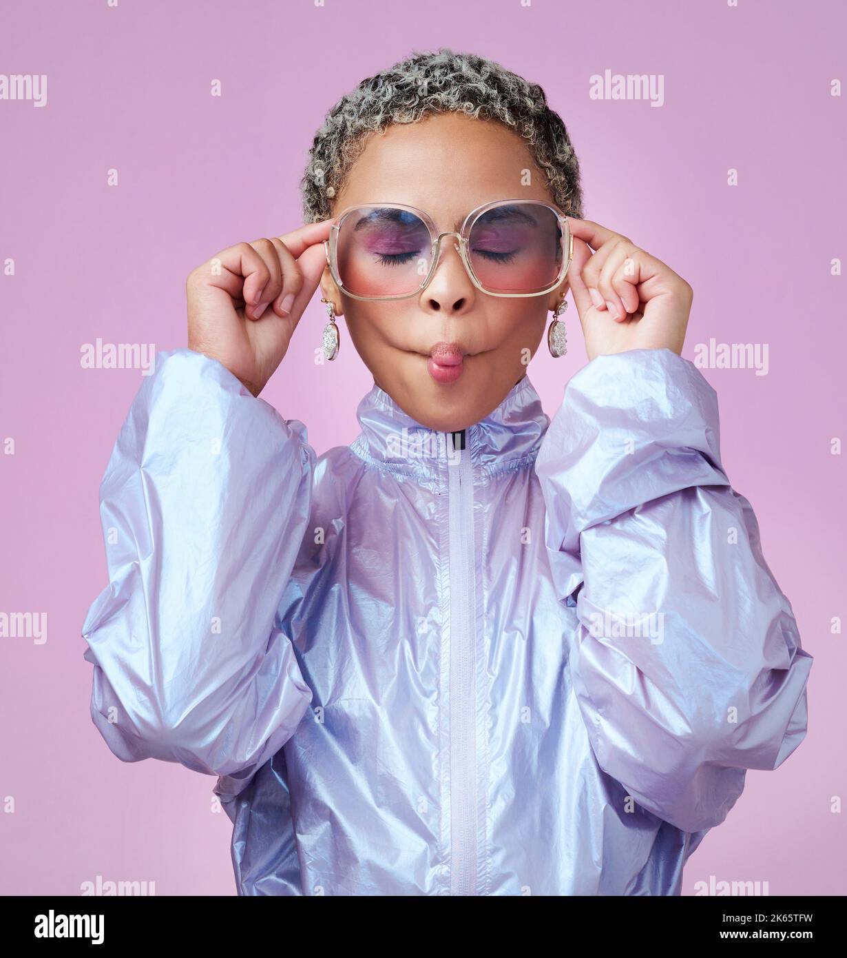 Fashion, beauty and lips with a black woman or model in sunglasses pouting in studio on a pink background. Trendy, style and edgy with an attractive Stock Photo