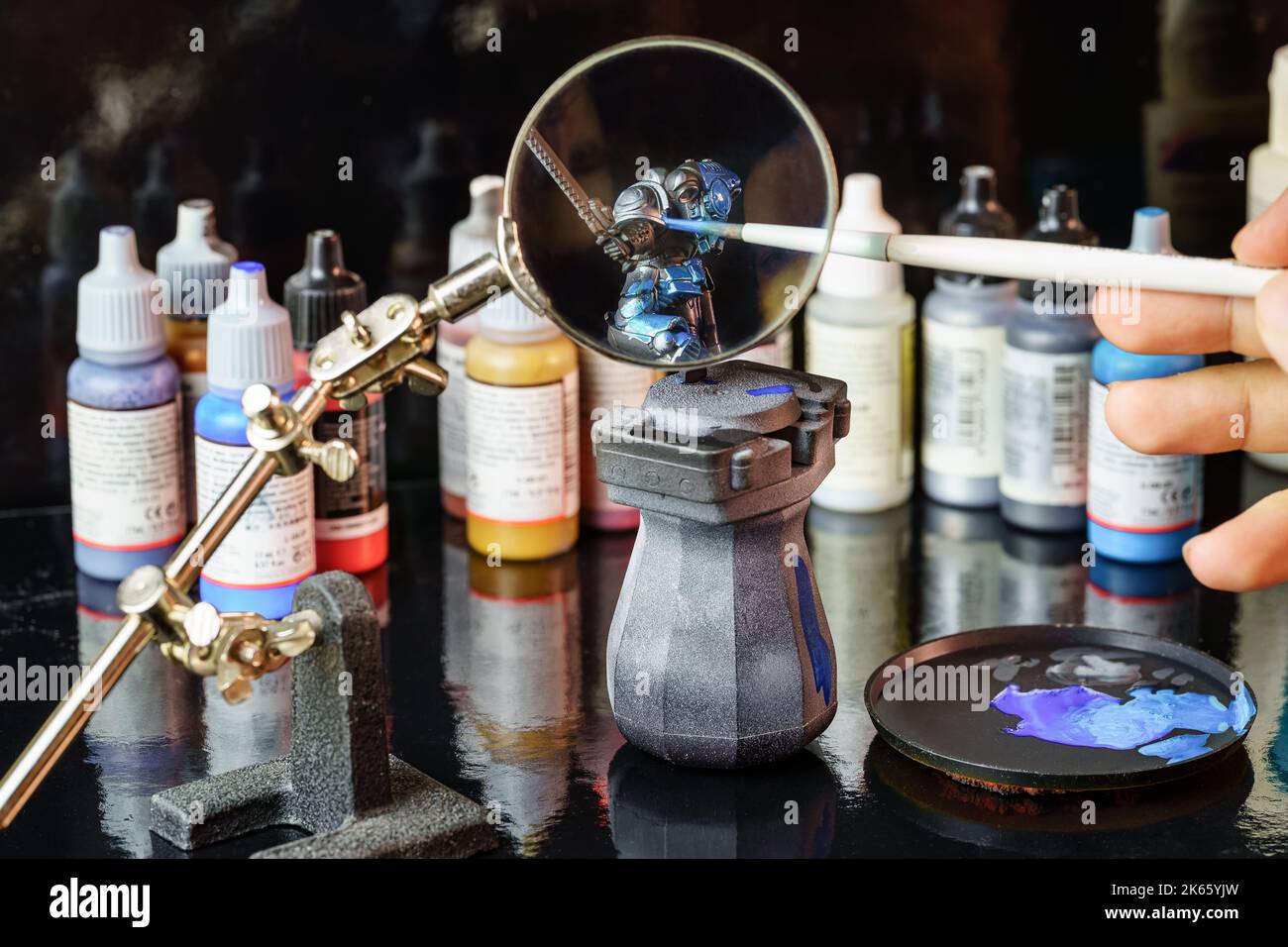 Giant magnifying glass to facilitate the painting of small figures of