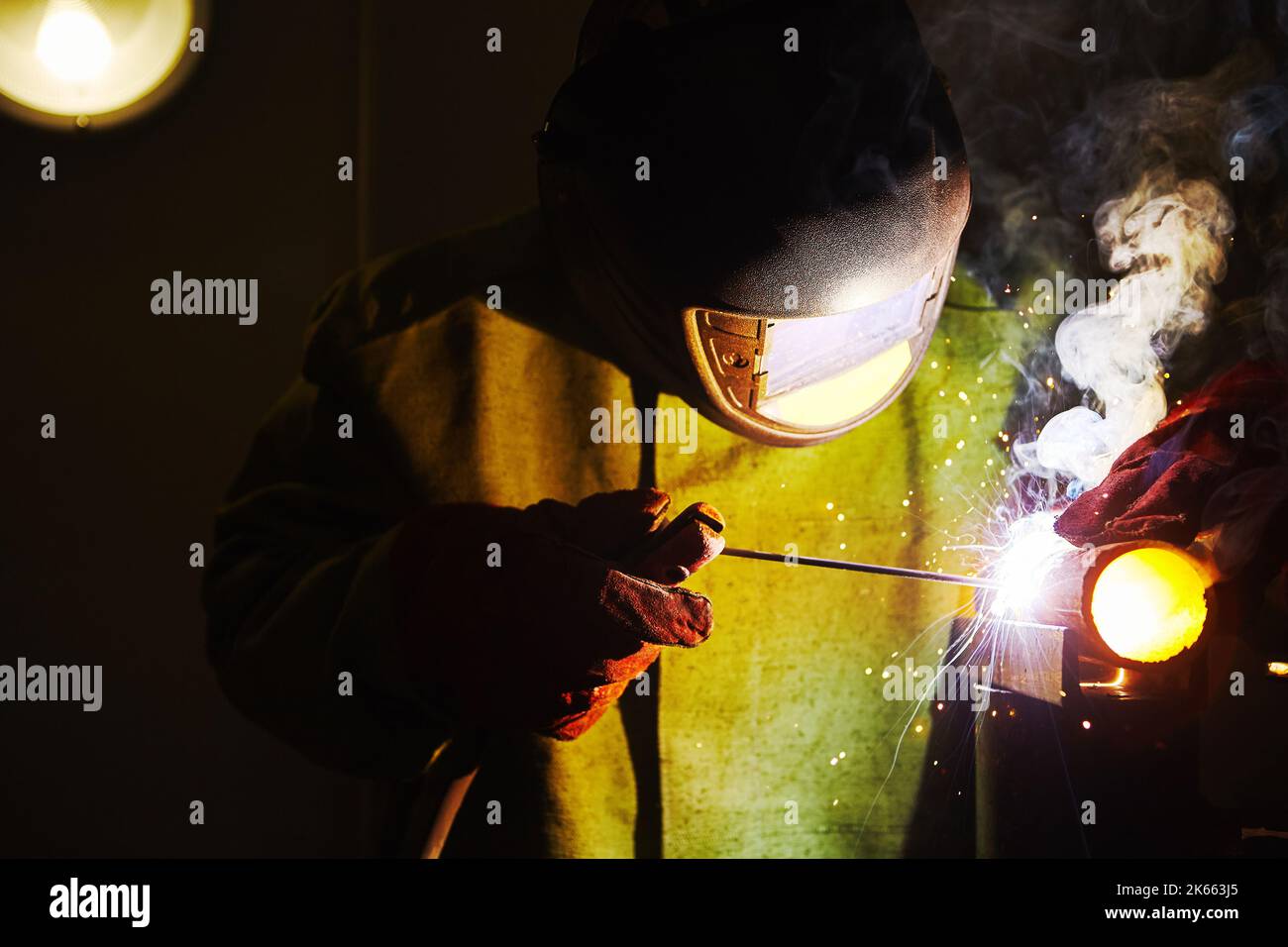 Worker in safety mask welds metal at industrial enterprises Stock Photo Alamy