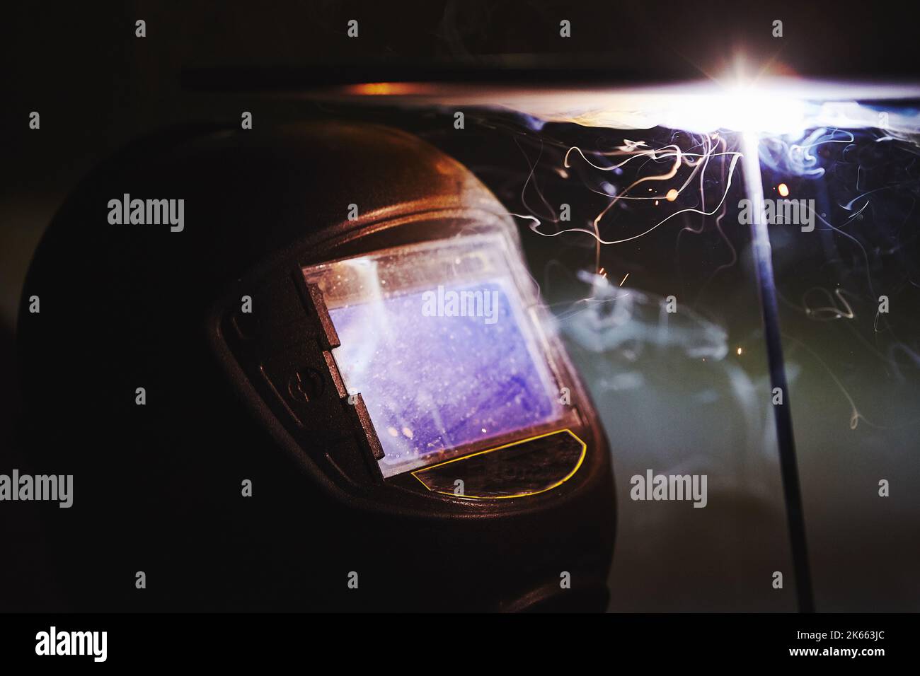 Man in protective mask welding metal construction. Stock Photo