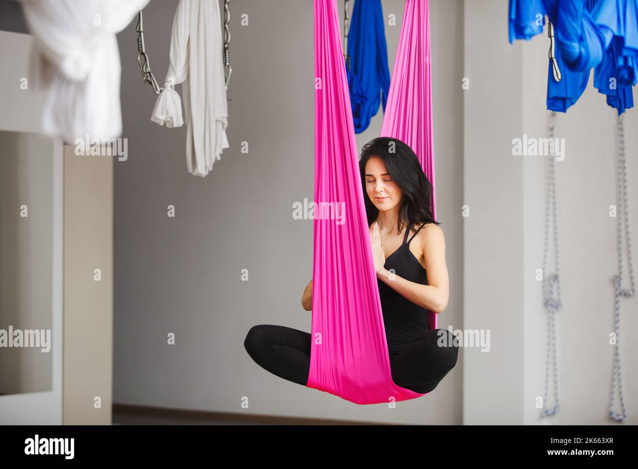 Aerial yoga girl in lotus pose on silk hammock Stock Photo Alamy