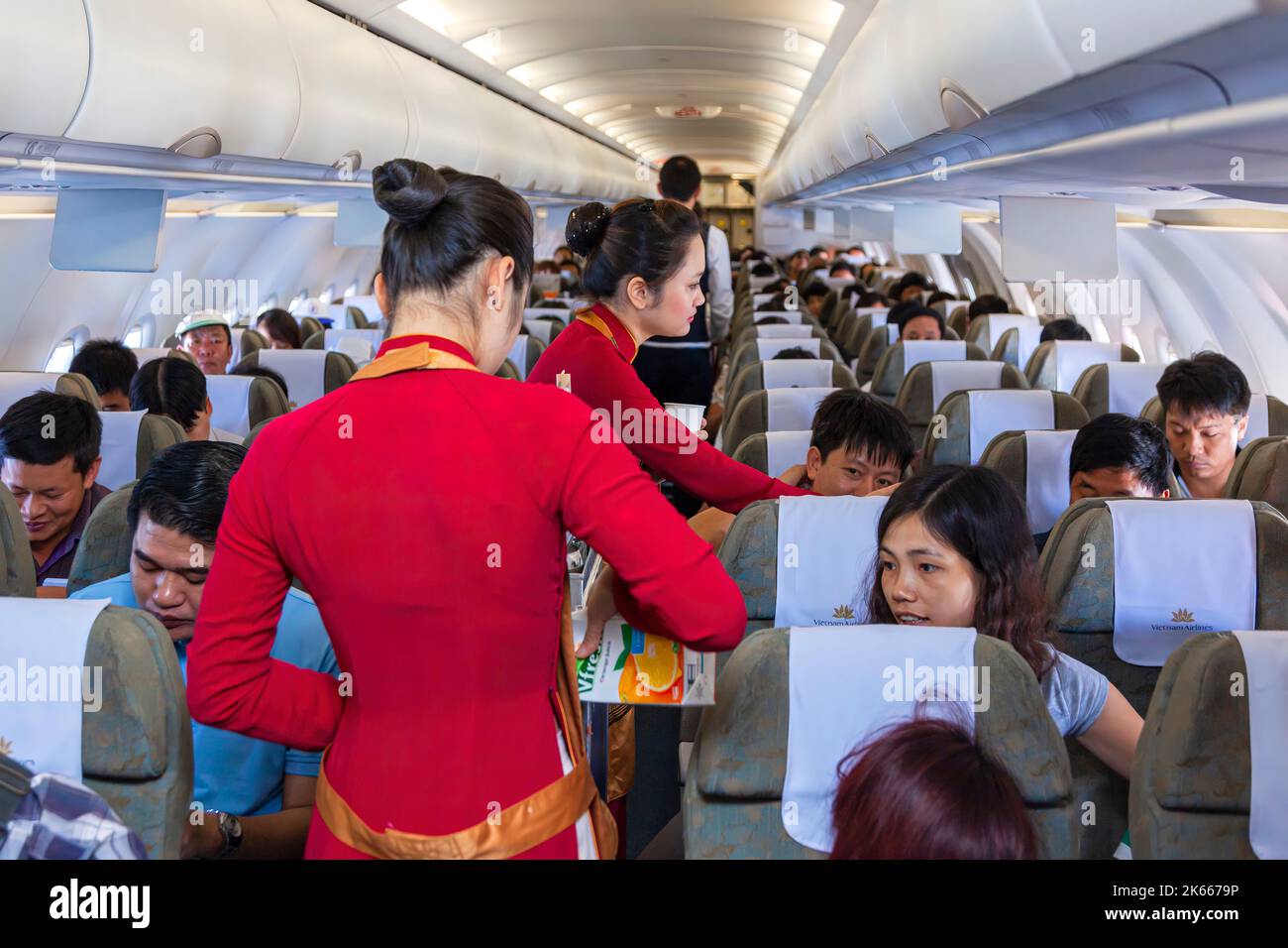 Flight crew and passengers on board Vietnam Airlines flight from Hanoi to Bangkok Stock Photo