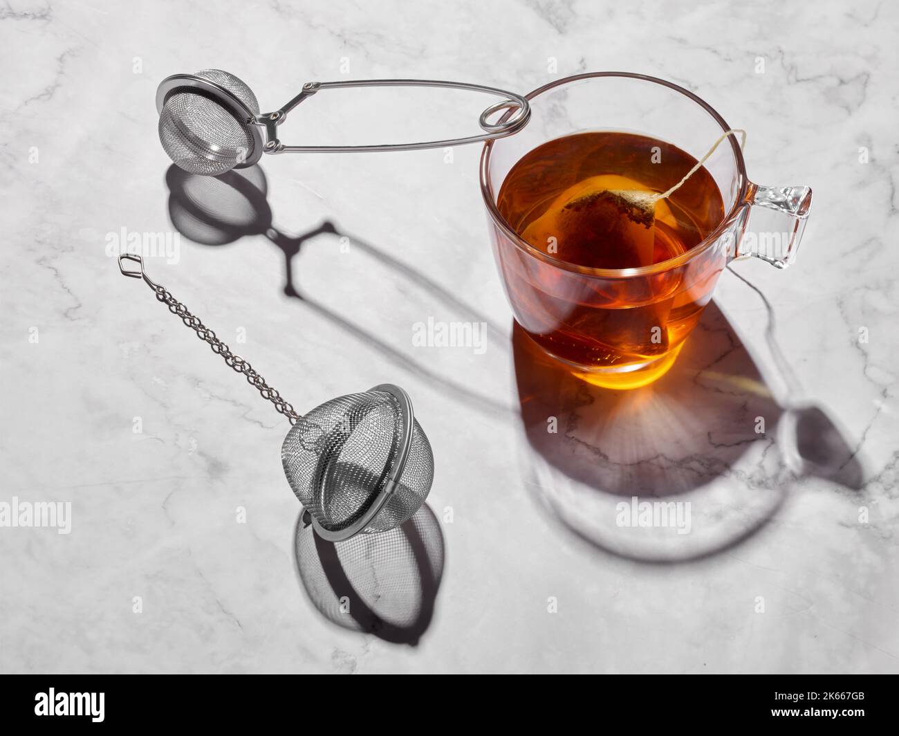 Glass cup with tea and tea filters Stock Photo Alamy