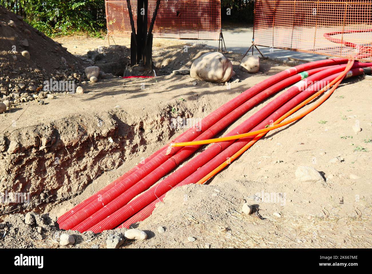 the length of pipes underground. red pipes in the pit Stock Photo Alamy