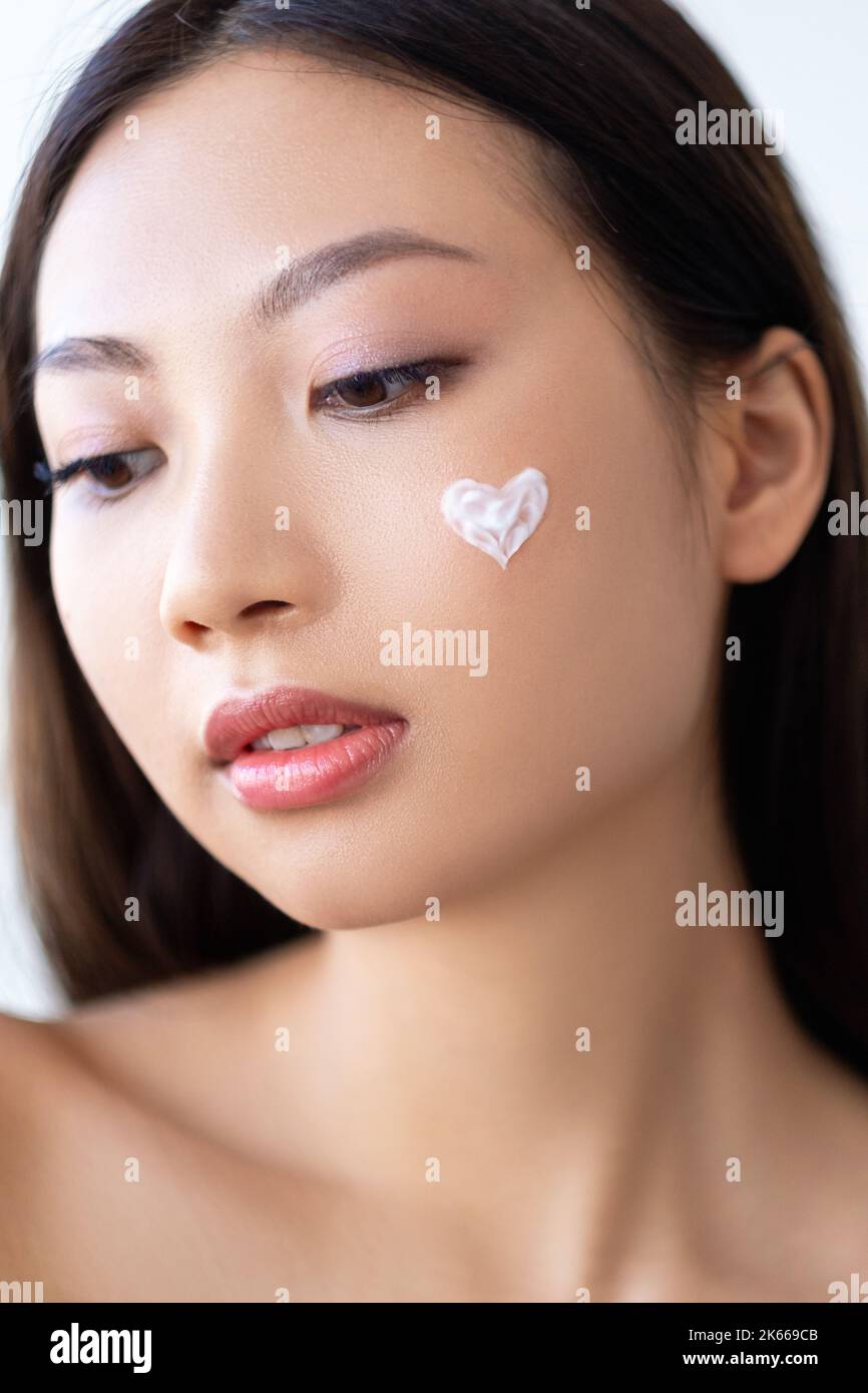 beauty care skin treatment woman cream on face Stock Photo