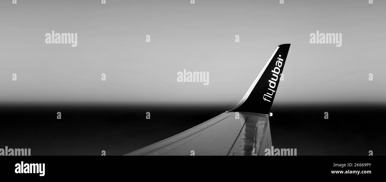 Wing of the FlyDubai airplane during a flight. Winglet of an airliner against the background of the dawn sky. 27.01.2022 Dubai Stock Photo