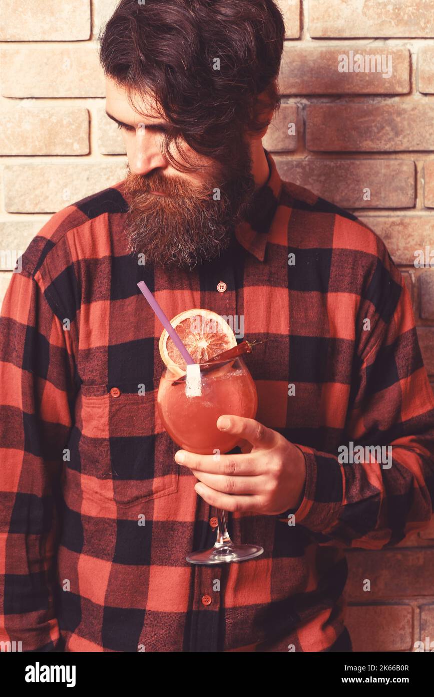 young bearded barman portrait on light brick wall background Stock Photo