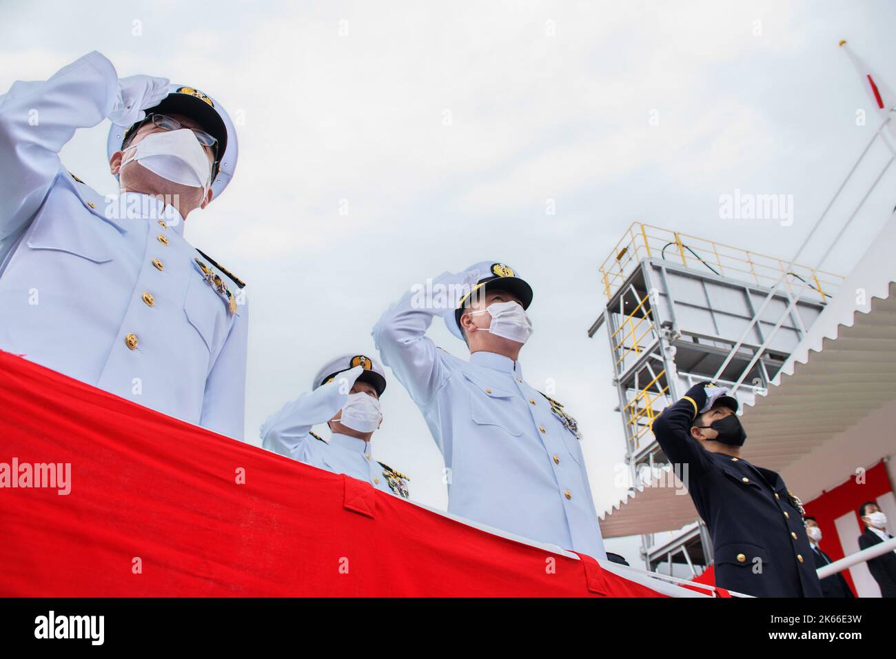 Kobe, Japan. 12th Oct, 2022. Japan Maritime Self?Defense Force's officers salute the National flag during the launching ceremony for new submarine 'Jingei' at Kobe Shipyard & Machinery Works of MHI in Kobe, Hyogo-Prefecture, Japan on October 12, 2022. Photo by Keizo Mori/UPI Credit: UPI/Alamy Live News Stock Photo