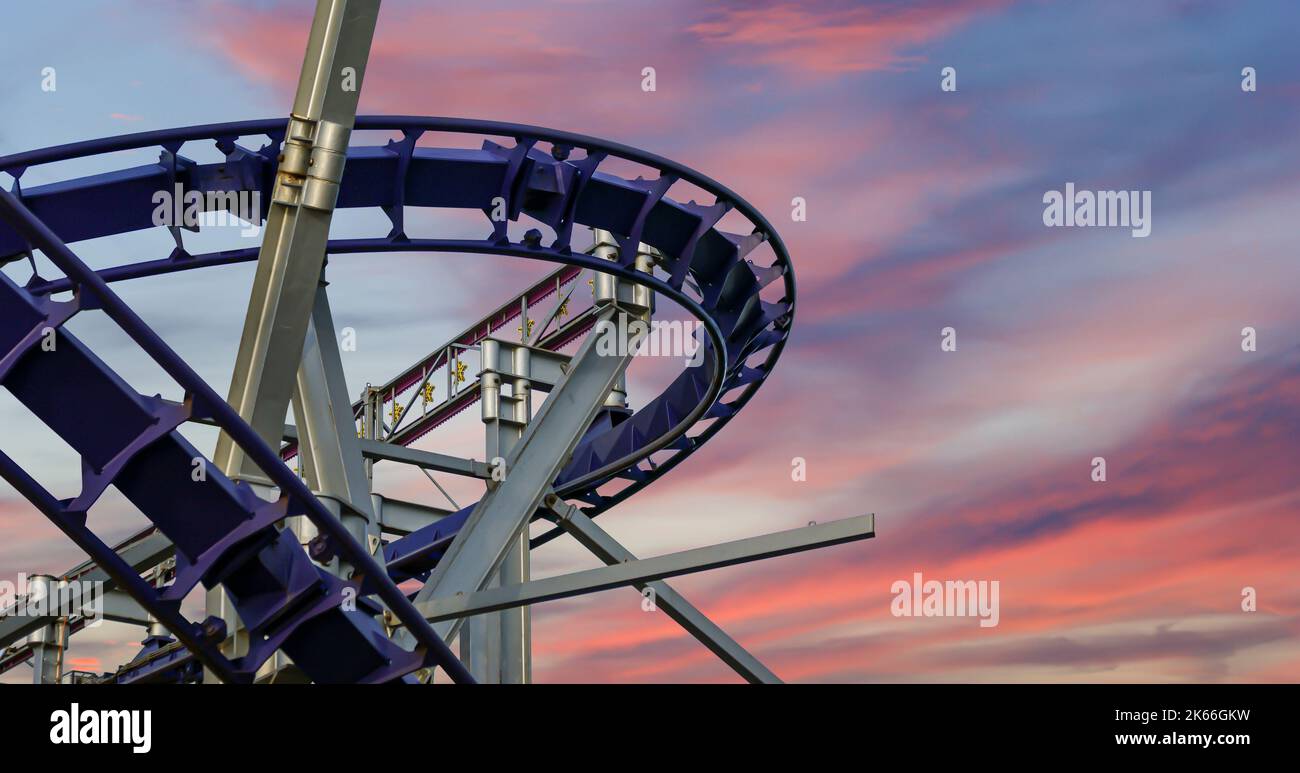 Attraction rollercoaster (switchback) against the background of a
