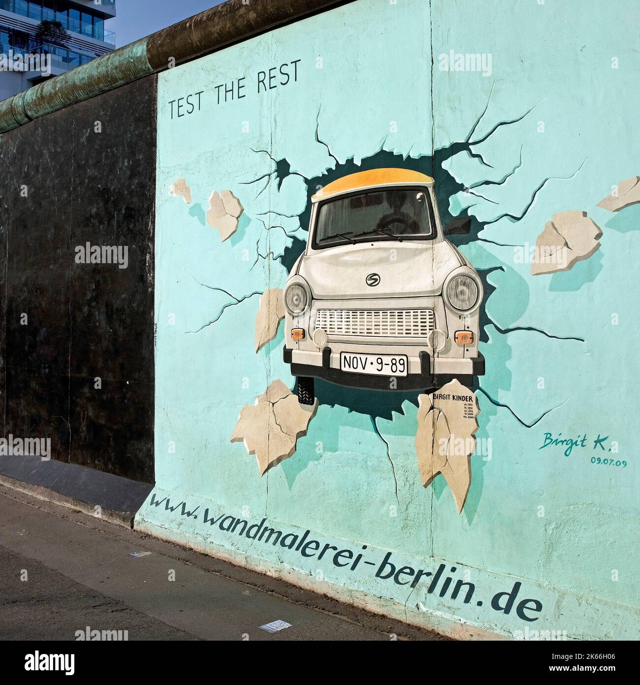 mural on the residue of the Berlin Wall, East Side Gallery, Trabi bursting a wall, Germany, Berlin Stock Photo