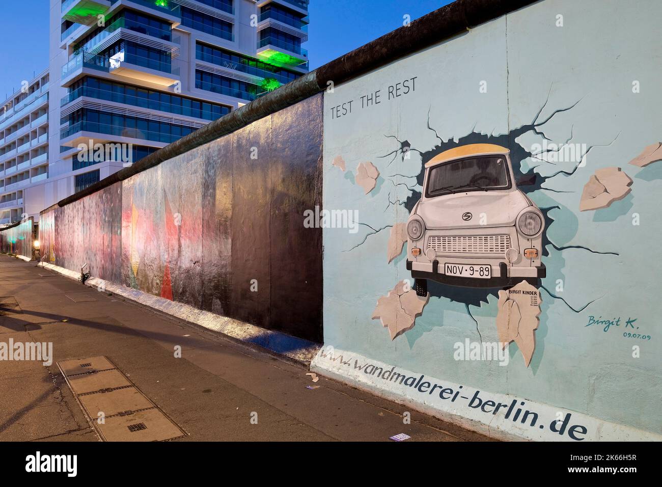mural on the residue of the Berlin Wall, East Side Gallery, Trabi bursting a wall, Germany, Berlin Stock Photo