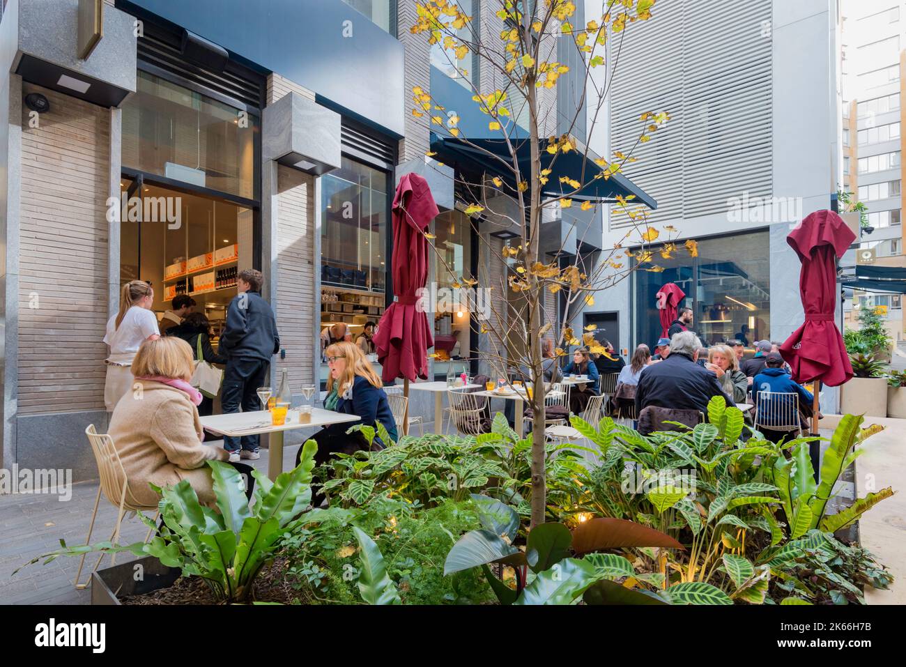 People sitting at outdoor tables at a café that forms part of the new Quay Quarter Laneways retail offering in Sydney, New South Wales, Australia Stock Photo