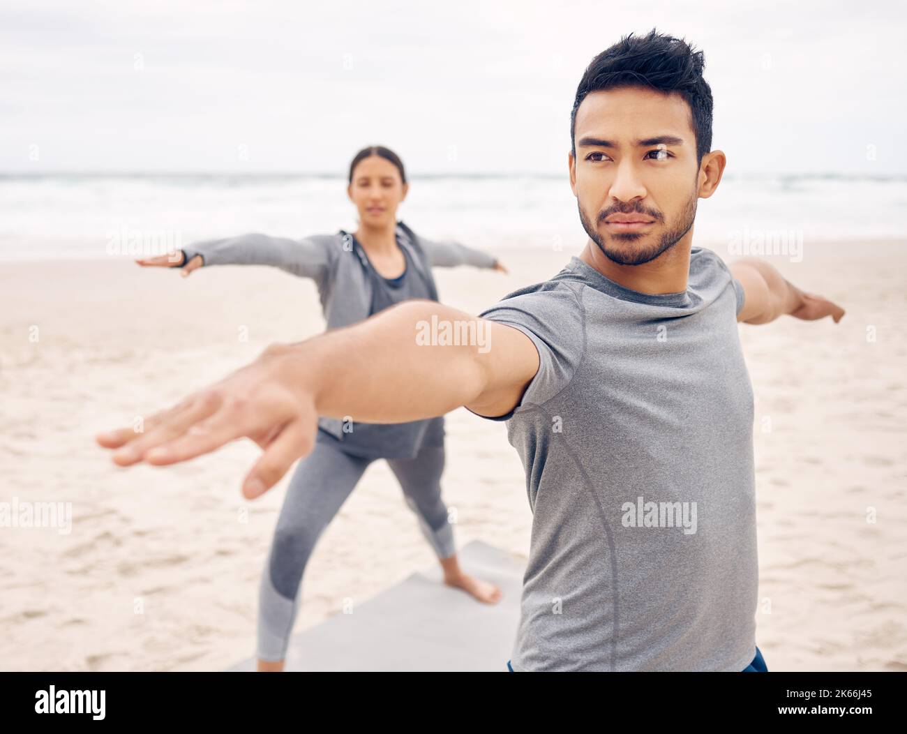 Boosting mood and mental clarity. a sporty young couple doing a warrior