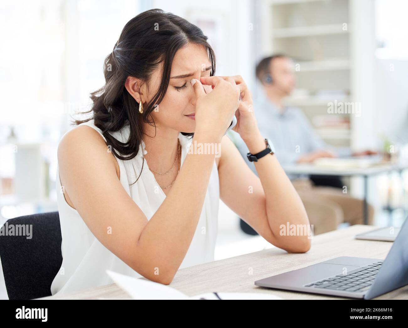 Im struggling hard today. a young businesswoman looking stressed out while talking on a cellphone in an office. Stock Photo