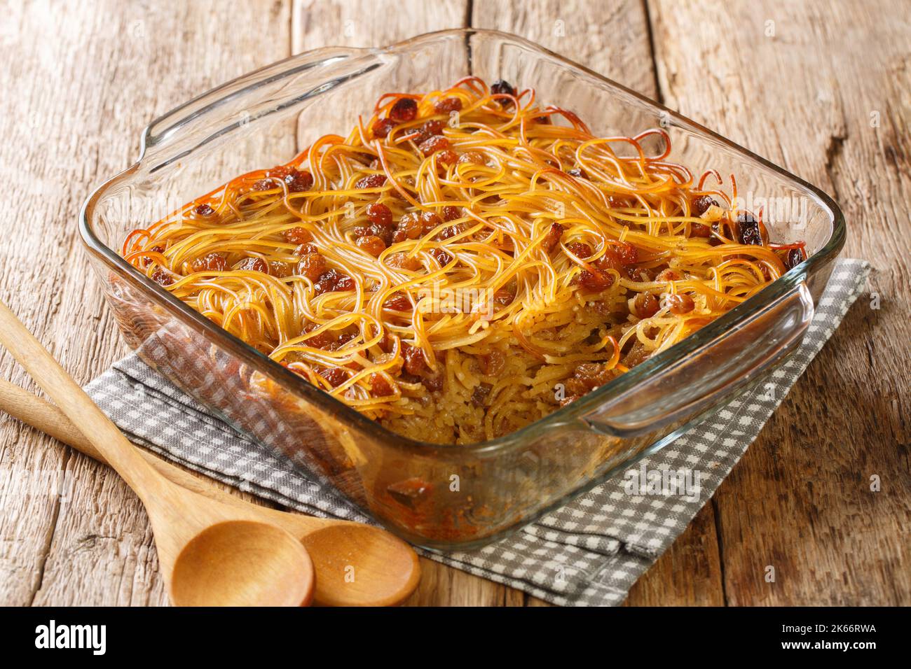 Jerusalem noodle kugel a Jewish pie for Shabbat Kodesh close-up in a glass bowl on the table. Horizontal Stock Photo