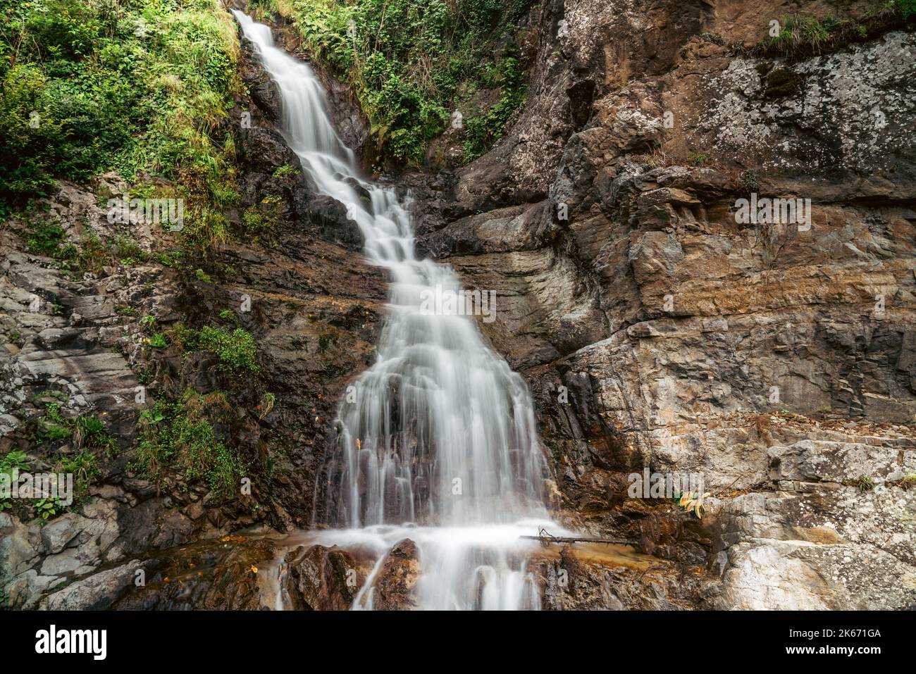 A stunning view of a waterfall in a green forest. High quality photo Stock Photo