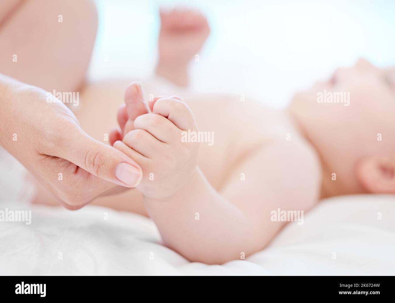 Im gonna take care of you. a baby and mother bonding on a bed at home. Stock Photo