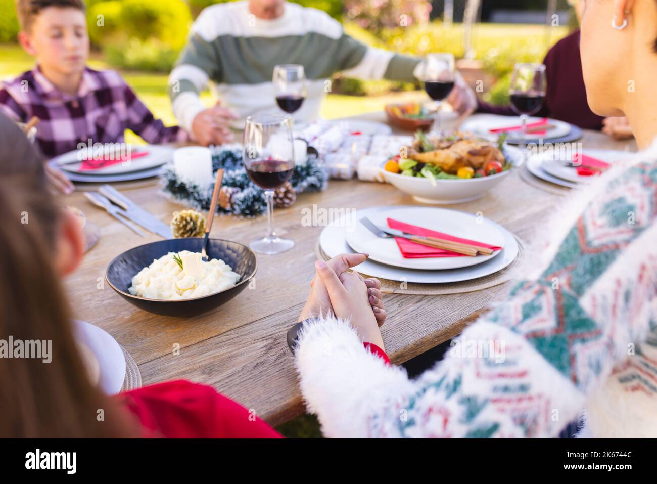 Caucasian family spending time together outside and praying before meal Stock Photo