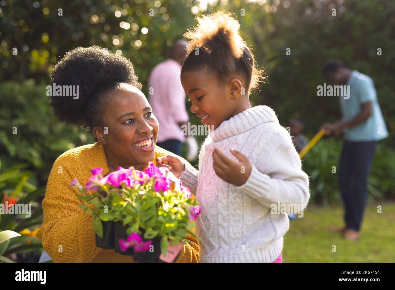 African american family spending time together in the garden and ...