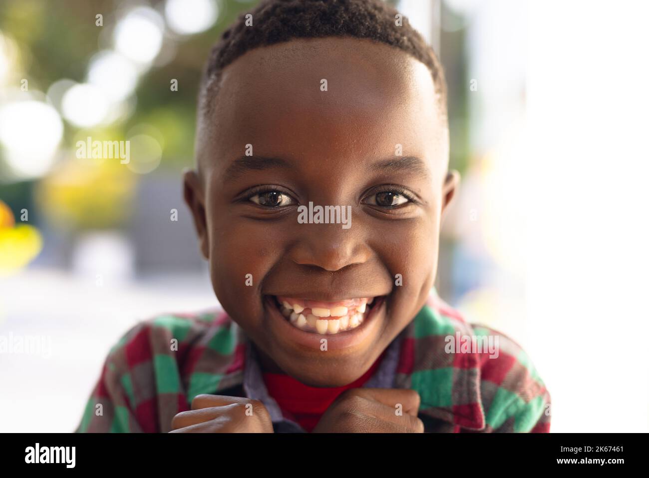 Happy smiling african american boy welcoming somebody outside the house Stock Photo