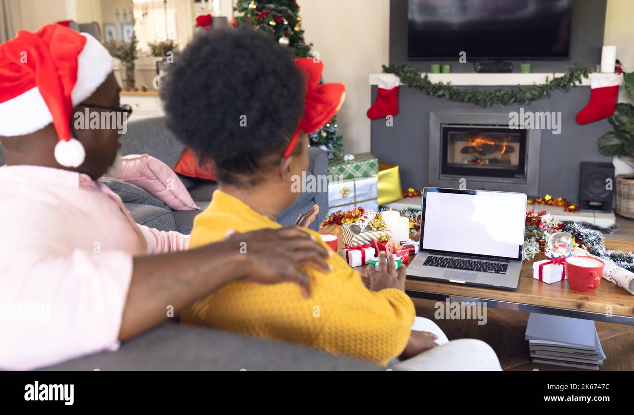 African american couple having face time and using laptop with copy space Stock Photo