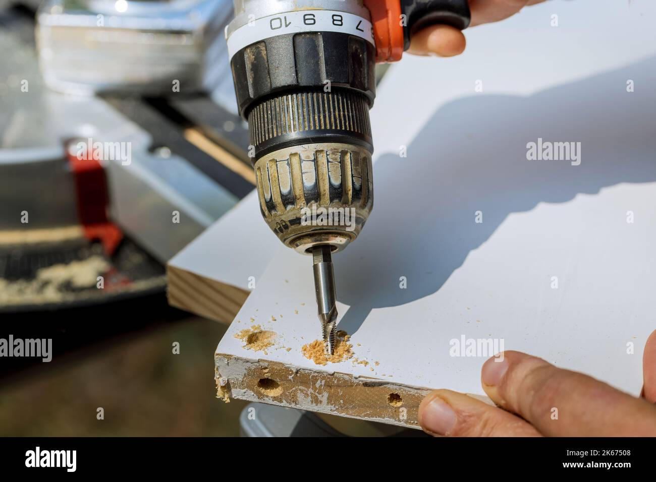 Carpenter drilling wood boards into using screwdriver for purpose of