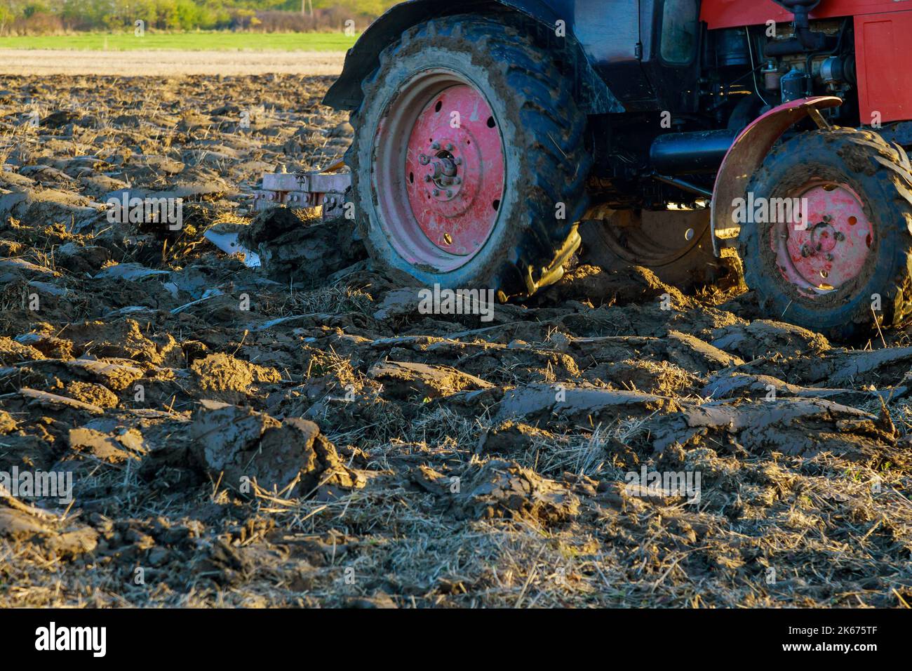 Tractor plows the autumn field after harvesting Stock Photo - Alamy