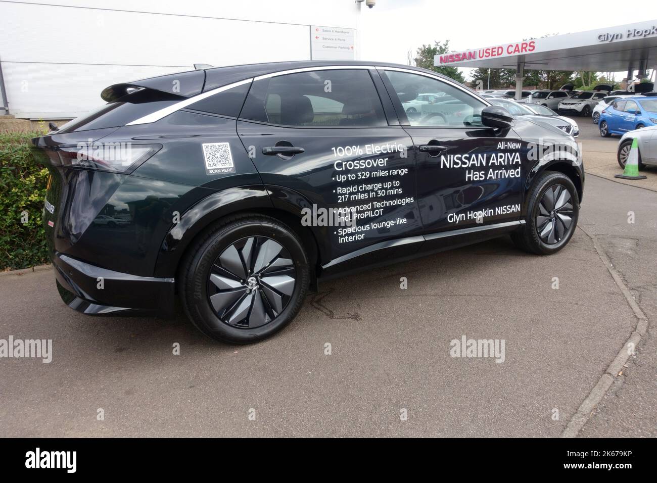 New Nissan Ariya crossover electric car with signage text promoting its credentials Glyn Hopkin Romford UK Stock Photo