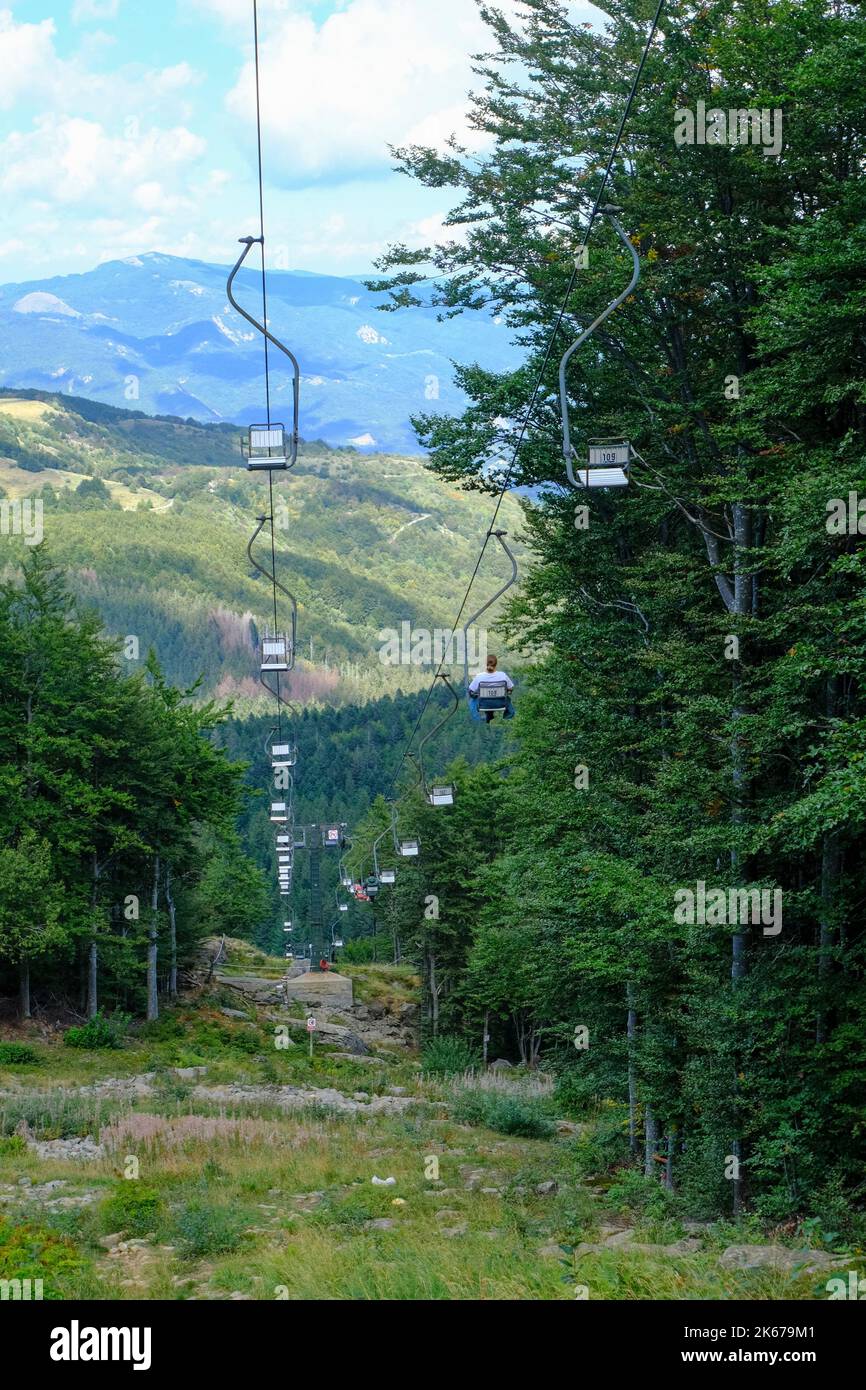 Chairlift across the mountains and cloudy sky. National park Appennino Tosco-Emiliano. Lagdei, Emilia-Romagna Stock Photo