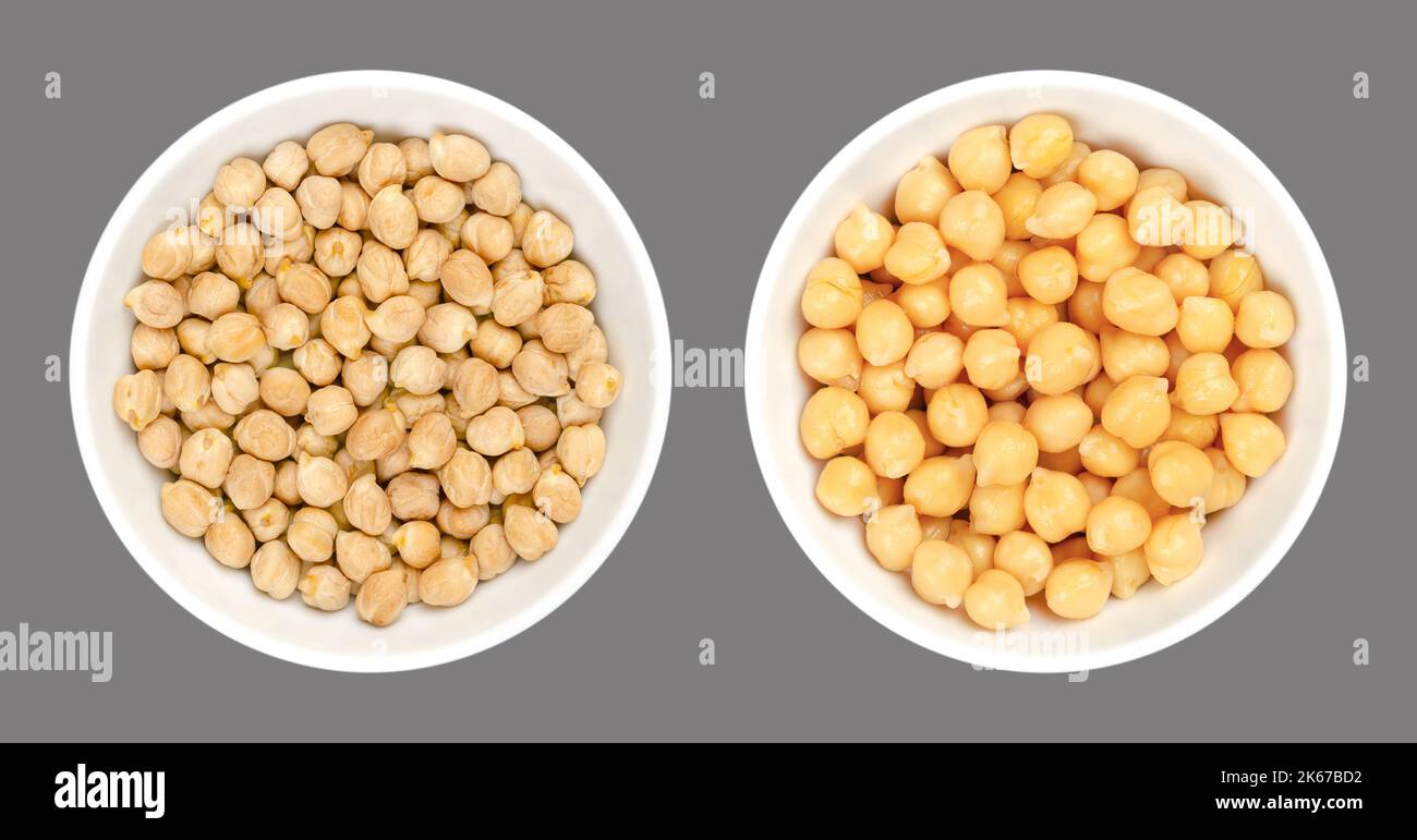 Chickpeas, dried and boiled, in white bowls, over gray. Raw and cooked chick peas, high in protein seeds of Cicer arietinum, a legume. Stock Photo