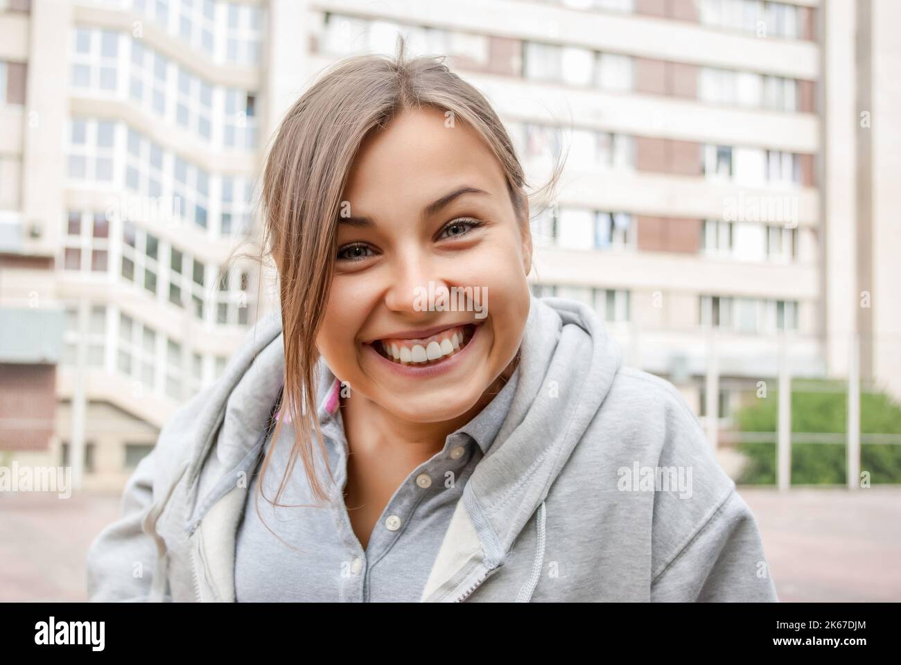 Cheerful young girl. A funny smile. Rest on street Stock Photo