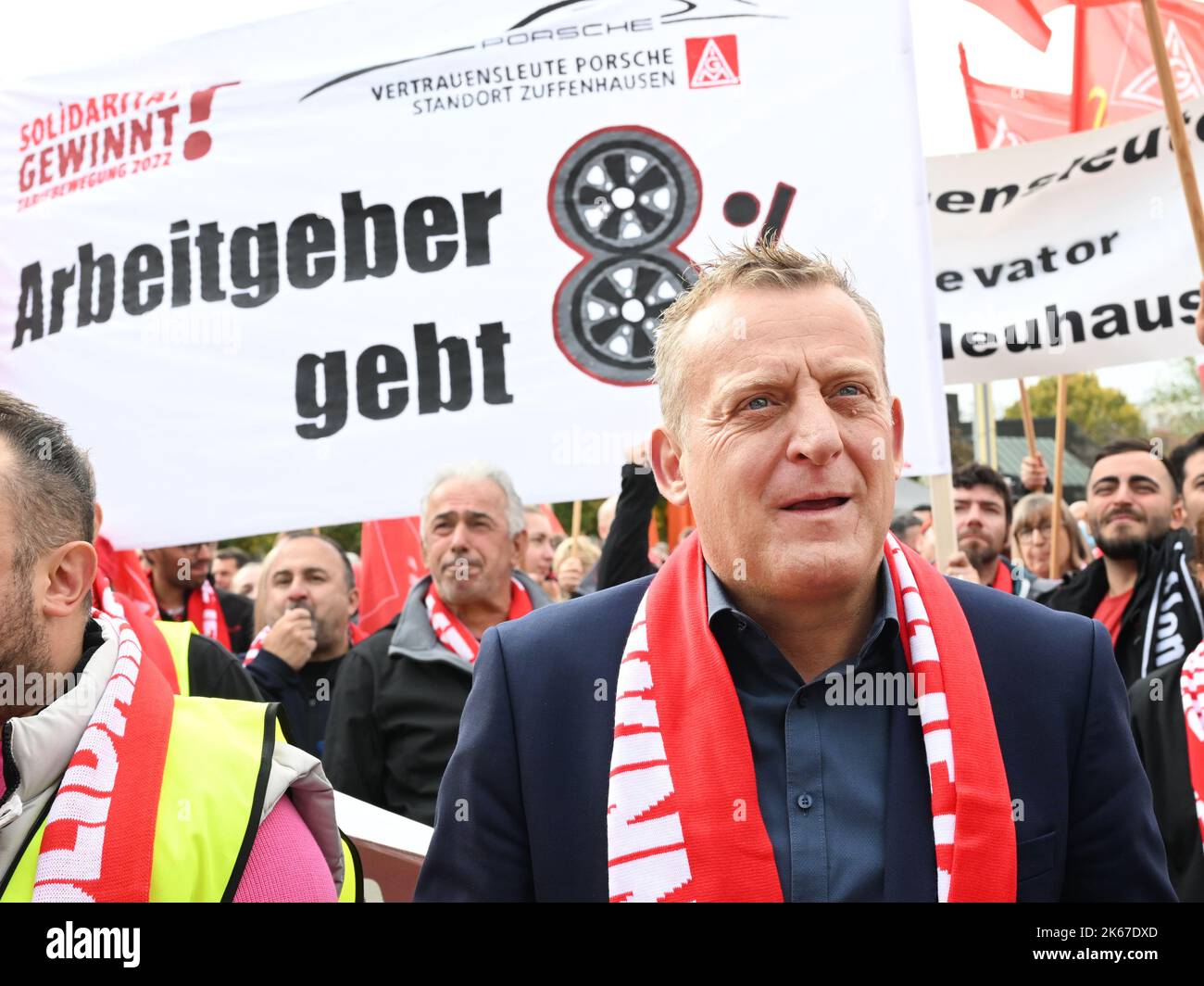 Kornwestheim, Germany. 12th Oct, 2022. Roman Zitzelsberger, head of the Baden-Württemberg district of the IG Metall union, stands with demonstrators gathered outside the negotiating hall before the second round of collective bargaining in the metal and electrical industry in Baden-Württemberg. Credit: Bernd Weißbrod/dpa/Alamy Live News Stock Photo